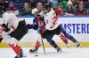 Canada forward Marie-Philip Poulin, right, is defended by United States forward Kelly Pannek (12) during the first period of a Rivalry Series women's hockey game, Saturday, Nov. 8, 2025, in Buffalo, N.Y. (AP Photo/Adrian Kraus)
