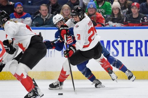 Canada forward Marie-Philip Poulin, right, is defended by United States forward Kelly Pannek (12) during the first period of a Rivalry Series women's hockey game, Saturday, Nov. 8, 2025, in Buffalo, N.Y. (AP Photo/Adrian Kraus)