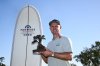 Justin Rose, of England, holds the winner's trophy at the Farmers Insurance Open golf tournament Sunday, Feb. 1, 2026, at Torrey Pines in San Diego. (AP Photo/Denis Poroy)