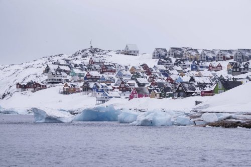 Coloured houses covered by snow are seen from the sea in Nuuk, Greenland on Thursday March 6, 2025. (AP Photo/Evgeniy Maloletka)