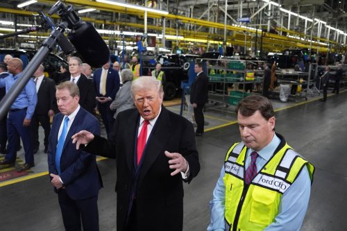 President Donald Trump speaks as Bill Ford, executive chairman of Ford, left, and Jim Farley, CEO of Ford, listen during a tour of the Ford River Rogue complex on Tuesday, Jan. 13, 2026, in Dearborn, Mich. (AP Photo/Evan Vucci)
