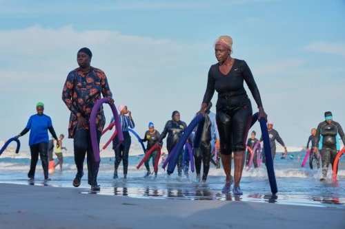 Participants walk out of the ocean after a group aquatic therapy session in Dakar, Senegal, Saturday, Dec. 13, 2025. (AP Photo/Misper Apawu)
