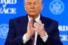President Donald Trump applauses during a signing ceremony on his Board of Peace initiative at the Annual Meeting of the World Economic Forum in Davos, Switzerland, Thursday, Jan. 22, 2026. (AP Photo/Markus Schreiber)