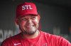 FILE - St. Louis Cardinals guest coach Yadier Molina smiles in the dugout before the start of a baseball game against the Chicago Cubs Aug. 8, 2025, in St. Louis. (AP Photo/Jeff Roberson, File)