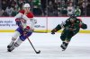 Montréal Canadiens left wing Juraj Slafkovský, left, skates with the puck as Minnesota Wild left wing Marcus Johansson (90) defends during overtime in an NHL hockey game Monday, Feb. 2, 2026, in St. Paul, Minn. (AP Photo/Matt Krohn)