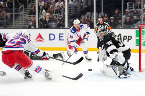 Los Angeles Kings goaltender Darcy Kuemper, right, stops a shot by New York Rangers center Jonny Brodzinski during the first period of an NHL hockey game Tuesday, Jan. 20, 2026, in Los Angeles. (AP Photo/Mark J. Terrill)