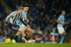 Newcastle's Nick Woltemade, left, and Manchester City's Nico O'Reilly fight for the ballduring the English League Cup semifinal soccer match soccer match between Manchester City and Newcastle in Manchester, England, Wednesday, Feb. 4, 2026. (AP Photo/Dave Thompson)