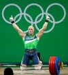 FILE - Aurimas Didzbalis, of Lithuania, celebrates after his final lift in the men's 94kg weightlifting competition at the 2016 Summer Olympics in Rio de Janeiro, Brazil, Aug. 13, 2016. (AP Photo/Mike Groll, File)