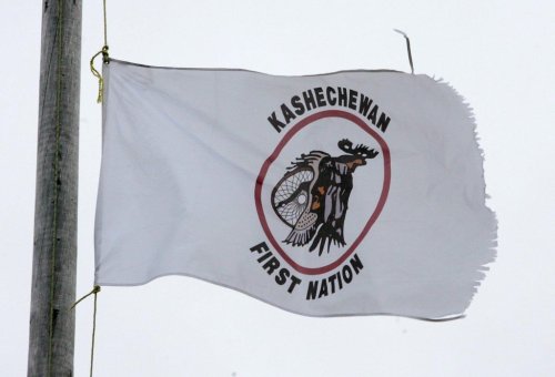 A tattered Kashechewan First Nation flag flies outside St. Paul's Anglician church on the Kashechewan native reserve in northern Ontario Sunday, Oct. 30, 2005. THE CANADIAN PRESS/Jonathan Hayward