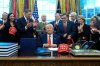 President Donald Trump smiles after signing a spending bill that ends a partial shutdown of the federal government in the Oval Office of the White House, Tuesday, Feb. 3, 2026, in Washington. (AP Photo/Alex Brandon)