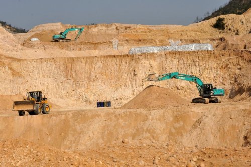 FILE - Workers use machinery to dig at a rare earth mine in Ganxian county in central China's Jiangxi province on Dec. 30, 2010. (Chinatopix via AP, File)