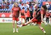 Canada's Janine Sonis, left, and Vanessa Gilles pass the ball during the warm-up ahead of their international friendly soccer match against Haiti in Montreal on Tuesday, June 3, 2025. THE CANADIAN PRESS/Graham Hughes