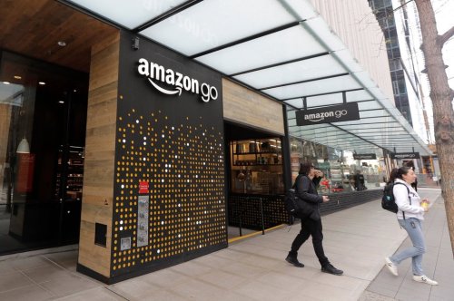 FILE - People walk out of an Amazon Go store in Seattle, March 4, 2020. (AP Photo/Ted S. Warren, File)