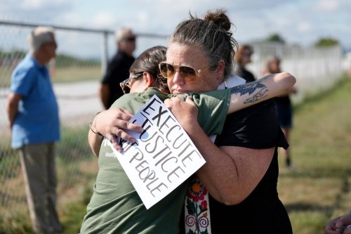 FILE - India Pungarcher, left, hugs Rev. Ingrid McIntyre as demonstrators gather in the area reserved for anti-death penalty protesters outside Riverbend Maximum Security Institution before the execution of Byron Black in Nashville, Tenn., Aug. 5, 2025. (AP Photo/Mark Humphrey, File)