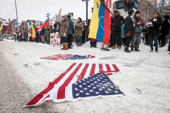 People gather Sunday afternoon at the intersection of River Avenue and Osborne Street to protest the United States’ arrest and capture of Venezuelan president Nicholas Maduro and his wife. (John Woods / Free Press)
