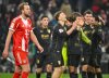 Bayern's Harry Kane walks as Augsburg's players celebrate at the end of the German Bundesliga soccer match between Bayern Munich and FC Augsburg in Munich, Saturday, Jan. 24, 2026. (Peter Kneffel/dpa via AP)