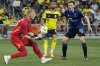 San Jose Earthquakes goalkeeper William Yarbrough, left, catches the ball during the second half of an MLS soccer match against Nashville SC, Saturday, April 27, 2024, in Nashville, Tenn. The Earthquakes and Nashville played to a 1-1 draw. (AP Photo/George Walker IV)