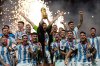 FILE - Argentina's Lionel Messi lifts the trophy after winning the World Cup final soccer match between Argentina and France at the Lusail Stadium in Lusail, Qatar, on Dec. 18, 2022. (AP Photo/Martin Meissner, File)