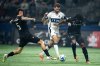 Vancouver FC's Matteo Campagna, left, Kunle Dada-Luke, right and Vancouver Whitecaps' Thomas Muller, centre, vie for the ball during the first half of the Canadian Championship final soccer match, in Vancouver, on Wednesday, October 1, 2025. THE CANADIAN PRESS/Ethan Cairns