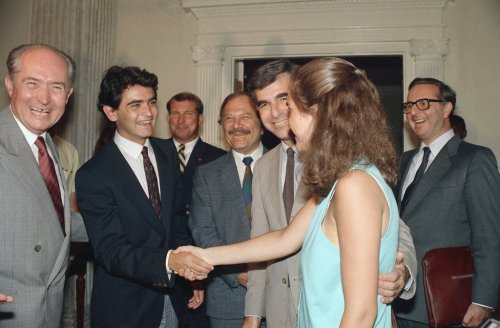 FILE -Cyprus President George Vassiliou, left, smiles as his son Evelthon, 17, is introduced to the daughter of Massachusetts Governor and Democratic presidential nominee Michael S. Dukakis, Kara, 19, at the Statehouse in Boston on Aug. 3, 1988 as Dukakis, second from right looks on, during a visit by the Cyprus President to Boston. (AP Photo/Carol Francavilla, File)