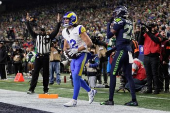 Los Angeles Rams wide receiver Puka Nacua (12) celebrates his touchdown catch next to Seattle Seahawks cornerback Riq Woolen (27) during the second half of the NFC Championship NFL football game Sunday, Jan. 25, 2026, in Seattle. (AP Photo/John Froschauer)