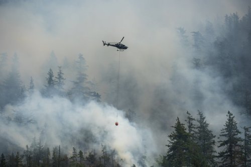 An aerial crew works on the Dryden Creek fire, an a out-of-control wildfire, just north of Squamish, B.C., on Tuesday, June 10, 2025. THE CANADIAN PRESS/Tijana Martin