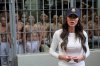 FILE - As prisoners stand looking out from a cell, Homeland Security Secretary Kristi Noem speaks during a tour of the Terrorist Confinement Center in Tecoluca, El Salvador, March 26, 2025. (AP Photo/Alex Brandon, File)