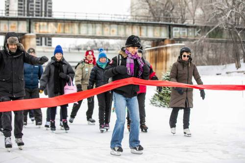 MIKAELA MACKENZIE / FREE PRESS
                                Skaters officially open the Nestawaya River Trail by skating through a red ribbon on New Year&rsquo;s Day.