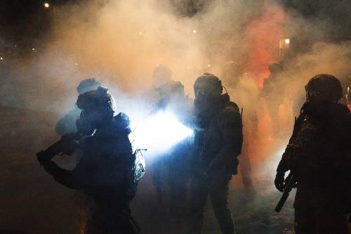 RICHARD TSONG-TAATARII / THE MINNESOTA STAR TRIBUNE
                                Federal agents deploy chemical irritants as they try to push demonstrators farther from the scene where a federal agent shot a man in north Minneapolis on Wednesday.