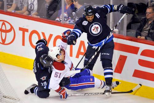 Fred Greenslade / REUTERS FILES
                                Former Winnipeg Jets fan favourite, Dustin Byfuglien, standing, has agreed to suit up for an alumni game that will be held prior to the Heritage Classic next fall between the Winnipeg Jets and the Montreal Canadiens.
