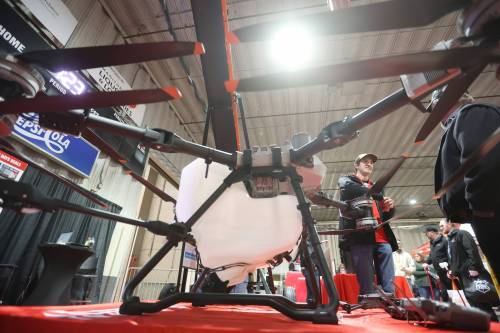 20012026 Todd Fraser with Flaman speaks with a visitor to Manitoba Ag Days 2026 about the uses for a DJI Agras T100 drone on display at the Flaman booth on Tuesday. (Tim Smith/The Brandon Sun)