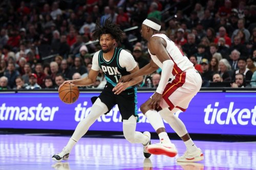 Portland Trail Blazers guard Shaedon Sharpe (17) drives to the basket as Miami Heat center Bam Adebayo (13) defends during the second half of an NBA basketball game Thursday, Jan. 22, 2026, in Portland, Ore. (AP Photo/Amanda Loman)