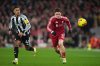 Newcastle's Jacob Ramsey and Liverpool's Florian Wirtz challenge for the ball during the English Premier League soccer match between Liverpool and Newcastle in Liverpool, England, Saturday, Jan. 31, 2026.(AP Photo/Jon Super)