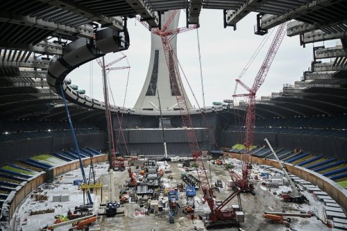 Cranes are shown inside the Olympic Stadium during the replacement of the roof in Montreal, Thursday, Jan. 8, 2026. THE CANADIAN PRESS/Graham Hughes