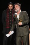 Rufus Wainwright, right, accepts the award for best audio book, narration, and storytelling recording for 