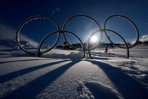 FILE - Olympic rings are displayed in the snow at the Stelvio Ski Center, venue for the alpine ski and ski mountaineering disciplines at the 2026 Milan Cortina Winter Olympics in Bormio, Italy, Jan. 16, 2025. (AP Photo/Luca Bruno, File)