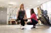 Sarah Baldassaro, left, demonstrates a strength-training regimen with her trainer, Hilary Granat, at the Center for Orthopedic Rehab and Exercise on Thursday, Jan. 8, 2026, in Washington. (AP Photo/Moriah Ratner)