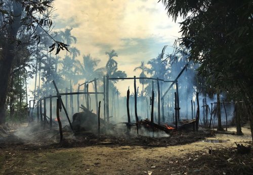 FILE - In this Sept. 7, 2017, file photo, smoke rises from a burned house in Gawdu Zara village, northern Rakhine state, where the vast majority of the country's 1.1 million Rohingya lived, Myanmar. (AP Photo, File)