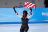 FILE - Erin Jackson of the United States hoists an American flag after winning the gold medal in the speedskating women's 500-meter race at the 2022 Winter Olympics, Sunday, Feb. 13, 2022, in Beijing. (AP Photo/Sue Ogrocki, file)