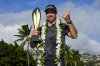 Nick Taylor, of Canada, poses with his trophy after winning the Sony Open golf event, Sunday, Jan. 12, 2025, at Waialae Country Club in Honolulu. (AP Photo/Matt York)