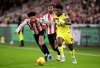 Brentford's Kevin Schade, left, and Tottenham Hotspur's Mohammed Kudus in action during the English Premier League soccer match between Brentford and Tottenham Hotspur in London, Thursday Jan. 1, 2026. (Adam Davy/PA via AP)