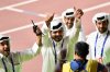 FILE - Sheikh Joaan bin Hamad bin Khalifa Al Thani, center, of Qatar, flashes two thumbs up when celebrating Mutaz Essa Barshim's gold medal in the men's high jump at the World Athletics Championships in Doha, Qatar, on Oct. 4, 2019. (AP Photo/Martin Meissner, File)