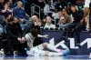 Charlotte Hornets guard LaMelo Ball holds his head after colliding with head coach Charles Lee during the first half of an NBA basketball game against the New Orleans Pelicans, in Charlotte, N.C., Monday, Feb. 2, 2026. (AP Photo/Nell Redmond)
