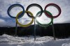 An athlete skis past Olympic rings during a cross-country training session at the 2026 Winter Olympics, in Tesero, Italy, Thursday, Feb. 5, 2026. (AP Photo/Kirsty Wigglesworth)