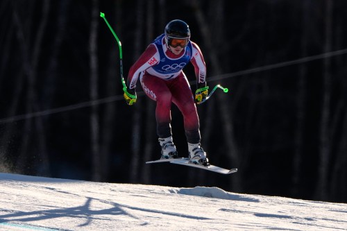 Canada's James Crawford speeds down the course during an alpine ski, men's downhill race, at the 2026 Winter Olympics, in Bormio, Italy, Saturday, Feb. 7, 2026. (AP Photo/John Locher)