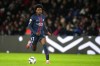FILE - PSG's Quentin Ndjantou Mbitcha runs with the ball during the French League One soccer match between Paris Saint-Germain and Auxerre at the Parc des Princes in Paris, Saturday, Sept. 27, 2025. (AP Photo/Thibault Camus, file)
