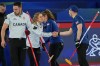 Canada's Jocelyn Peterman shakes hands with Britain's Bruce Mouat during the mixed doubles round robin phase of the curling competition at the 2026 Winter Olympics, in Cortina d'Ampezzo, Italy, Saturday, Feb. 7, 2026. (AP Photo/Fatima Shbair)