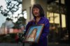 Carol Todd holds a photo of her late teenage daughter Amanda Todd, who died by suicide in 2012, and the necklace she was wearing in the school photo, outside B.C. Supreme Court after sentencing for the Dutch man who was accused of extorting and harassing her daughter, in New Westminster, B.C., on Friday, Oct. 14, 2022. THE CANADIAN PRESS/Darryl Dyck