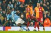 Manchester City's Jeremy Doku, left, is challenged by Galatasaray's Davinson Sanchez during the Champions League opening phase soccer match Manchester City and Galatasaray in Manchester, England, Wednesday, Jan. 28, 2026. (AP Photo/Dave Thompson)