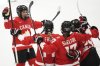Marie-Philip Poulin of Canada, right, celebrates with teammates after scoring her sides second goal during the semi final match between Canada and Finland at the Women's Ice Hockey Championships in Ceske Budejovice, Czech Republic, Saturday, April 19, 2025. (AP Photo/Petr David Josek)